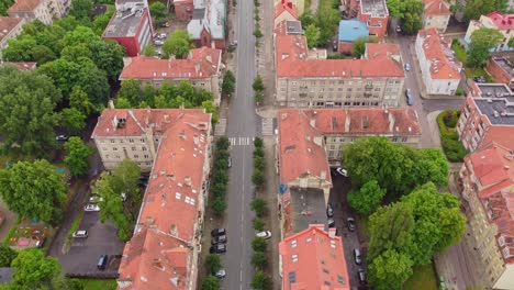 Flyover-Lithuanian-streets-of-Klaipeda,-aerial-drone-shot,-forward,-day