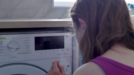 Caucasian-woman-using-smart-touchscreen-washing-machine-Slough-London-United-Kingdom-June-2024