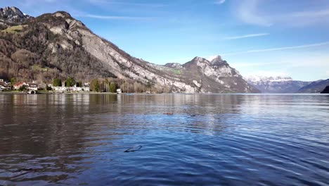 Mesmerising-view-of-Walensee-lake,-Switzerland--st-gallen-canton--quinten-featuring-village-on-shore-|-Whirl-created-by-throwing-a-wood-stick-in-water