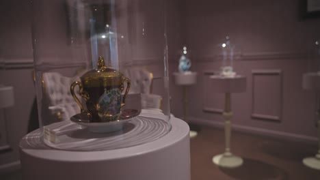 Elegant-tea-sets-displayed-under-glass-domes-in-a-sophisticated-room-at-the-Zagreb-Chocolate-Museum