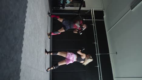 Vertical-shot-of-mma-fighters-sparring-at-indoor-gym-facility,-Czechia