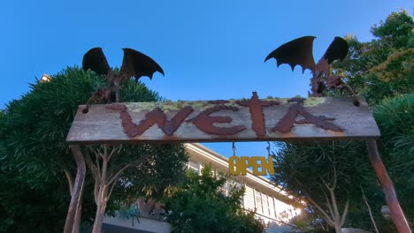 View-of-Weta-Cave-sign-at-film-production-shop-and-museum-in-Wellington,-New-Zealand-Aotearoa