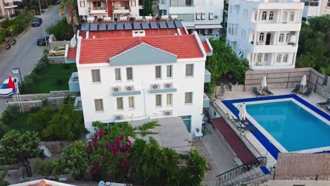 Aerial-view-of-swimming-pool-and-houses-of-Datça-city,-Turkey