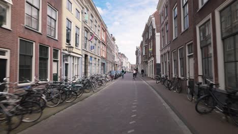 Cycling-On-The-Street-Of-Hogewoerd-In-Leiden,-South-Holland,-Netherlands