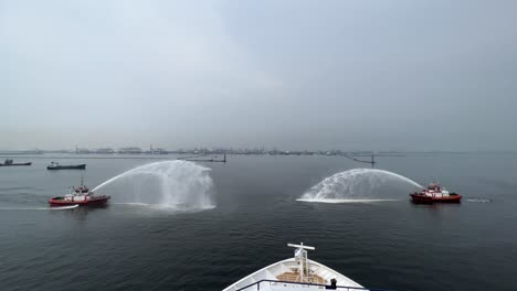 Tugboats-Doing-Water-Salute-Ceremony-By-Spraying-Waters-From-Fire-Extinguishers