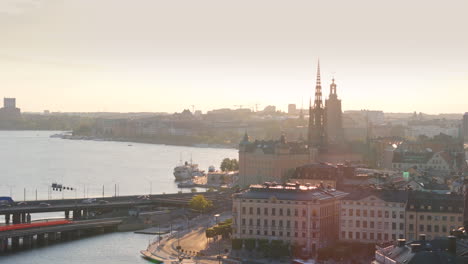 Sunset-aerial-view-of-Gamla-Stan-on-Riddarfjärden-with-traffic-on-Centralbron