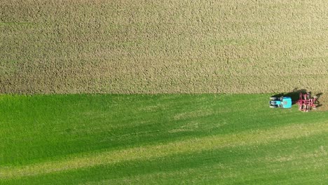 Tractor-working-on-the-field,-drone-footage