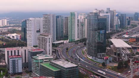 Aerial-top-view-of-skyscraper-offices-in-Santa-Fe-area-and-highway-in-Mexico-City