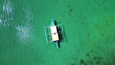 Woman-Waving-While-Zooming-Out-Aerial-In-Kayangan-Lake