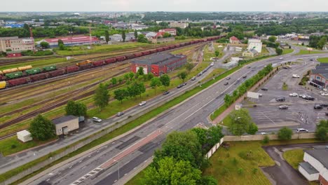 Railway-station-and-highway-road-in-Klaipeda,-Lithuania,-aerial-view