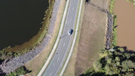 Aerial-view-of-a-road-on-the-spillway-between-two-lakes