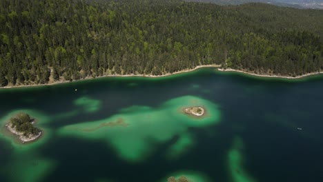 Eibsee-Bayern-Germany-aerial-pan-up-from-island-to-the-mountains