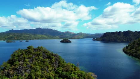 Kayangan-Lake-Aerial-Of-Coron-In-Distance-With-Limestone-Mountains-All-Around