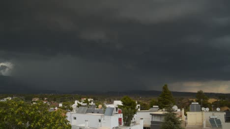 Dark-massive-black-thunder-clouds-over-Parnitha-mountain,-Greece,-lighting-strikes-in-the-shot