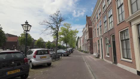 Riding-Bicycle-On-The-Streets-Of-Oude-Singel-In-Leiden,-South-Holland,-Netherlands