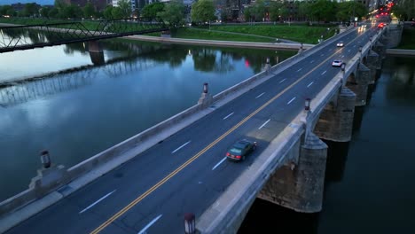 Aerial-descending-flight-over-bridge-and-driving-cars-in-Harrisburg-City