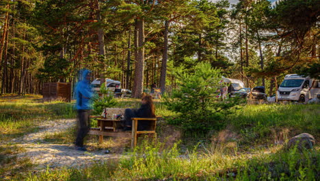 Couple-Enjoying-Picnic-on-Wooden-Bench-at-Campsite-in-Daytime