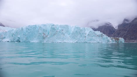 Glacier-and-Glacial-Arctic-Sea-Water,-Greenland,-View-From-Boat-Under-Ice-Mass