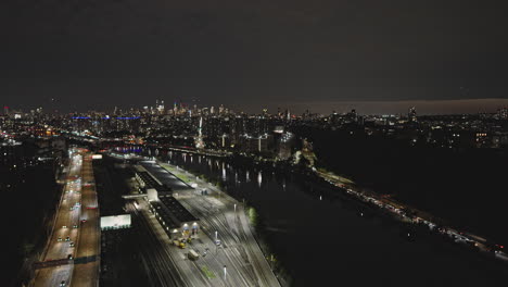 NYC-New-York-Aerial-v268-drone-flyover-Metro-North-Railroad-Highbridge-Yard-along-Harlem-river-capturing-night-cityscape-of-Washington-Heights-Upper-Manhattan---Shot-with-Inspire-3-8k---September-2023