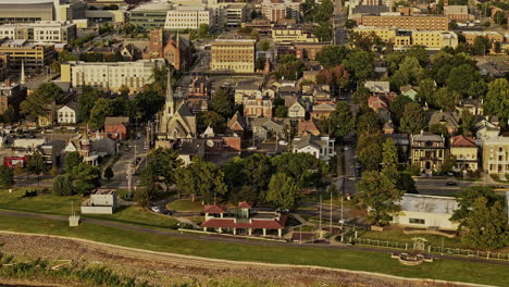 Evansville-Indiana-Aerial-v7-zoomed-birds-eye-view-drone-flyover-Riverside-and-Wheeler-neighborhoods,-capturing-town-center-views-in-golden-sunset-glow---Shot-with-Mavic-3-Pro-Cine---September-2023