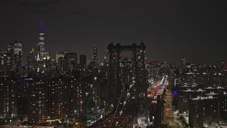 NYC-New-York-Aerial-v300-tracking-flyover-capturing-traffic-on-Williamsburg-Bridge-and-illuminated-downtown-cityscape-of-Lower-East-Side-Manhattan-at-night---Shot-with-Inspire-3-8k---September-2023