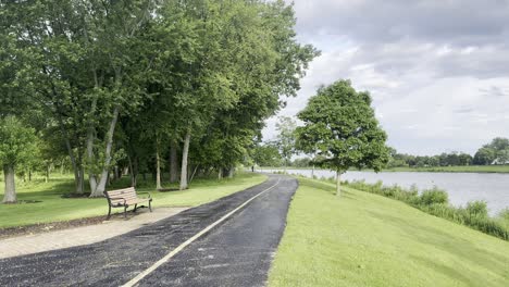 Beautiful-bike-path-near-a-lake-on-a-partly-cloudy-day