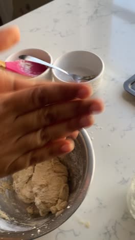 Vertical-video-of-adding-coconut-oil-into-a-batter-of-vegan-donut-batter