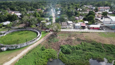 Low-aerial-approaches-circular-rodeo-ruin-in-Noh-Bec-pueblo-in-Mexico