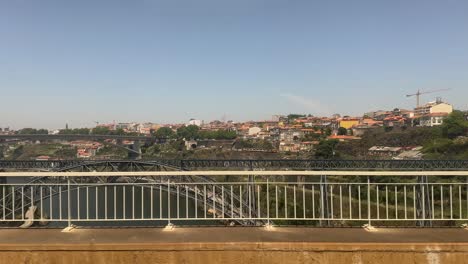 Point-of-view-from-a-commuter-train-crossing-Porto-to-Gaia,-Portugal