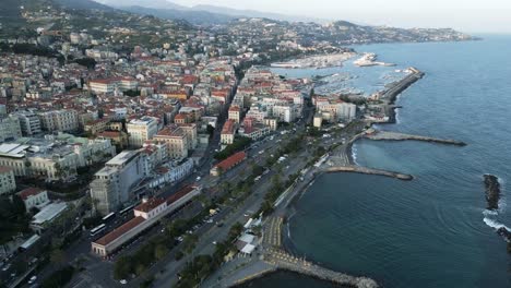 Sanremo-Italy-coastal-promenade-and-harbor-with-classical-architecture,-aerial-establishing-dolly