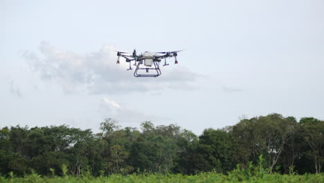 Drone-DJI-AGRAS-T30-hovering-in-the-air-spraying-pesticides-or-water-with-copy-space