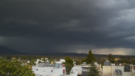 Slow-left-pan,-wide-panoramic-view-of-massive-thunderstorm-clouds,-over-Parnitha-mountain-and-cityscape-of-Adames,Greece-4K