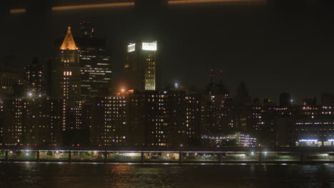 NYC-skyline,-traffic-on-Brooklyn-Bridge-at-nighttime,-scenic-view-of-night-citylife-in-New-York-City