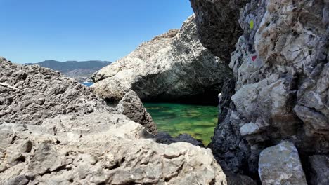 A-stunning-view-of-clear-blue-water-surrounded-by-rocky-cliffs-in-Sudak,-Crimea