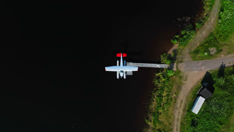 Top-down-drone-shot-above-a-sea-plane,-sunny-summer-day-in-Inari,-Finland