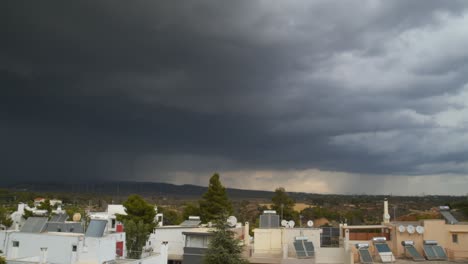 Lightning-discharge-over-Parnitha-mountain,-Greece,-Massive-amount-of-black-thunder-storm-clouds-right-pan,-wide-panoramic-footage-4K