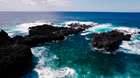 Ariel-shot-of-waves-hitting-the-seashore,-São-Miguel-Island,-Portugal