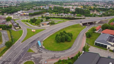 Multi-level-intersection-with-public-bus-driving-in-Klaipeda,-aerial-view