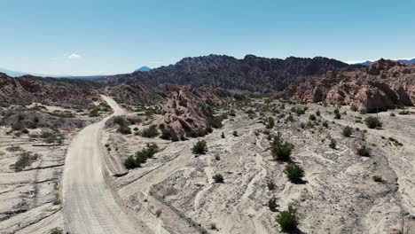 Blue-Car-Parked-In-The-Middle-Of-Ruta-40-At-Quebrada-De-Las-Flechas,-Salta-Province,-Argentina