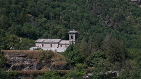 Aerial-view-of-the-historic-Novalesa-Abbey,-a-Benedictine-monastery-nestled-in-the-lush-landscape-of-Piedmont,-Turin,-Italy