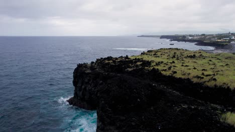 Ariel-shot-of-shoreline-of-São-Miguel-Island-in-Portugal,-waves-hitting-the-rock