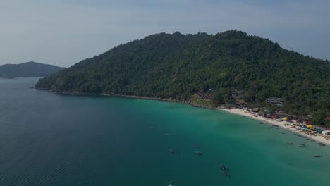 Aerial-view-of-long-beach-with-turquoise-water-and-boats,-showing-the-beauty-of-nature-in-malaysia