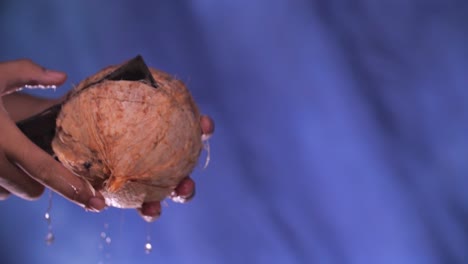 Hand-with-Knife-Chop-Whole-Coconut,-Close-Up