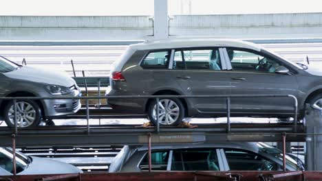 Cars-loaded-on-a-train-car-carrier-during-the-day,-ready-for-transportation