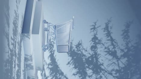 Empty-shopping-cart-on-a-blue-platform-with-shadow-of-branches-on-a-blue-background