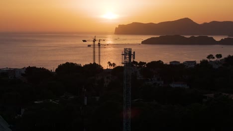 Aerial---scenic-view-of-golden-hour-sunset-over-Mediterranean-bay,-Mallorca