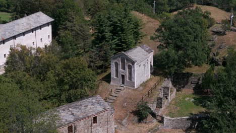 Aerial-shot-of-the-historic-Novalesa-Abbey-and-chapel-located-in-the-scenic-Turin-region-of-Piedmont,-Italy