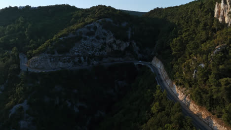 Drone-shot-tracking-cars-on-a-mountainous-road-in-Istria,-sunny-evening-in-Croatia