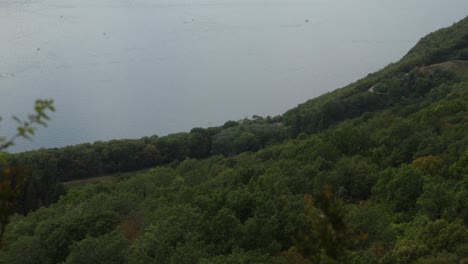 Above-dense-forest-near-Lake-Bourget-in-Aix-les-Bains,-France,-viewpoint