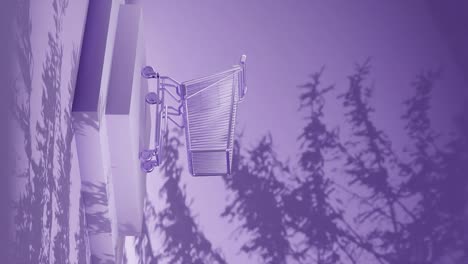 Empty-shopping-cart-on-a-purple-platform-with-shadow-of-branches-on-a-purple-background